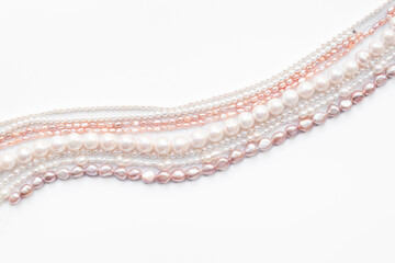 A lot of chains of precious pearls - beads for jewelry, top view. Precious and elegance concept background