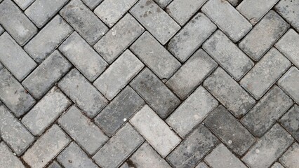Grey herringbone paving block texture background. walkway surface.
