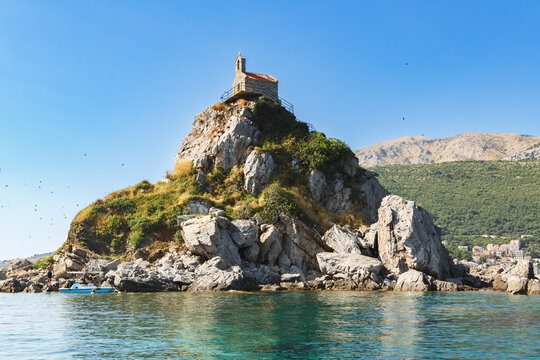Small Stone Chapel on Rocky Islet near Podgorica, Montenegro, Surrounded by Mountains and Blue Sea