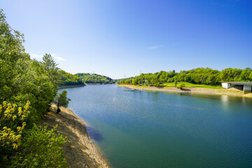 Fototapeta premium View of the Wuppertal Dam and the surrounding countryside. Landscape by the lake near Remscheid in the Bergisches Land region. 