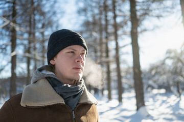 Portrait of man breathing in cold winter air