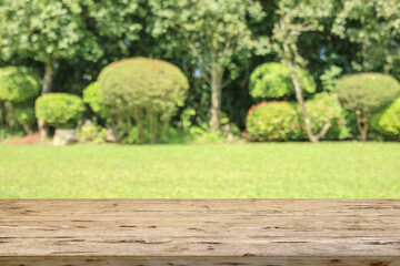 Fototapeta premium Empty wood table top with abstract blur park garden background