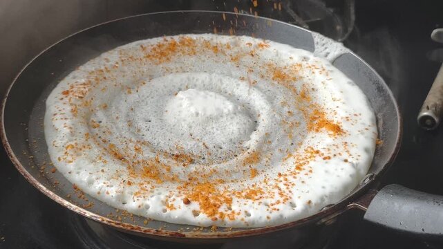 Traditional Ghee Roast Dosa Topped with Spicy Karam Podi Masala on Hot Tawa