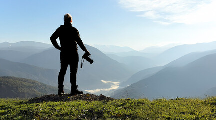 Nature photographer silhouette on hilltop scenic landscape