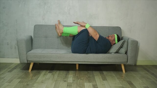 Funny fat man doing fitness at home.