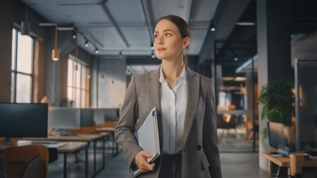 Ambitious Businesswoman Walks Confidently in a Modern Open plan Office
