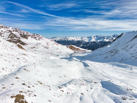 Aerial view of the valley with beautiful snowy mountains in a background, winter paradise