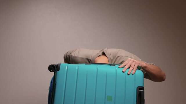 Traveler opening luggage, Close shot of hands unfastening suitcase zipper before travel, Detailed view of hands pulling zipper on vibrant teal travel case with anticipation