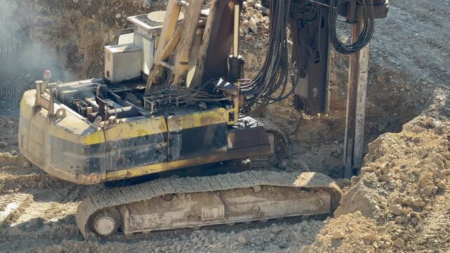 Crawler drilling rig operating at construction site. Equipment for drilling wells. Equipment for installing piles in ground, heavy machines for driving pillars work in laying the foundation building