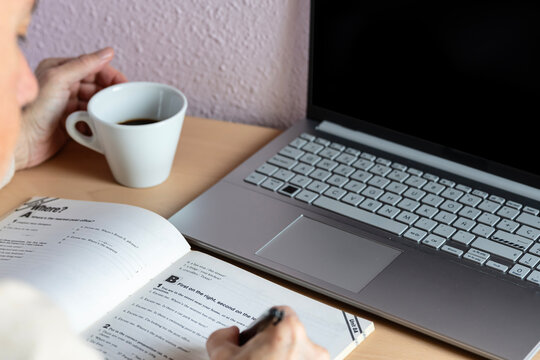 Adult learning languages at home with coffee