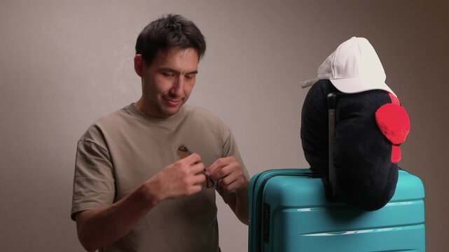 Man examines mannequin head attire. Person carefully checks fit of white hat on mannequin head. Casual individual reviews placement of white cap on mannequin before traveling