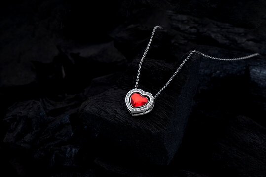 Stunning heart shaped locket with red gemstone on silver chain