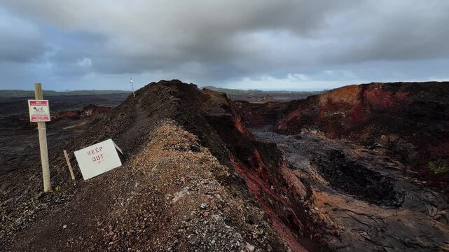 Dramatic volcanic fissure in Hawaii with rugged terrain and moody skies