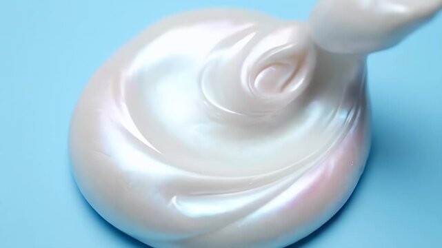 Iridescent White Slime with Liquid Drip on Blue Background for Play and Relaxation, Creative Texture for Art Projects