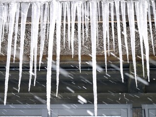 日本的な家屋の屋根から下がる氷柱