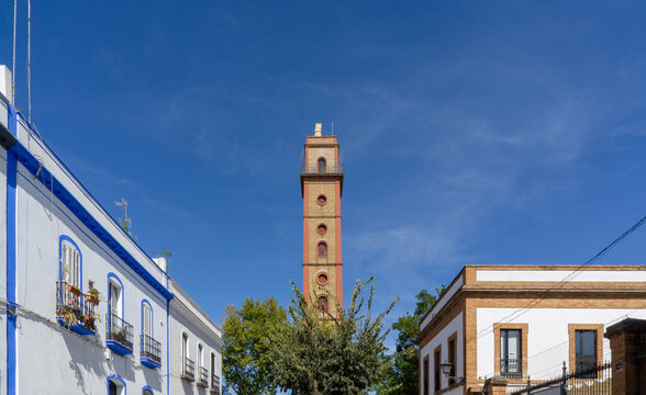 Historic Torre de los Perdigones Industrial Shot Tower in Seville Spain with Traditional Andalusian Architecture against Clear Blue Sky