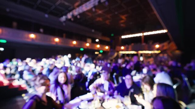Professional executives socialize at upscale gathering with ambient lighting and lively atmosphere