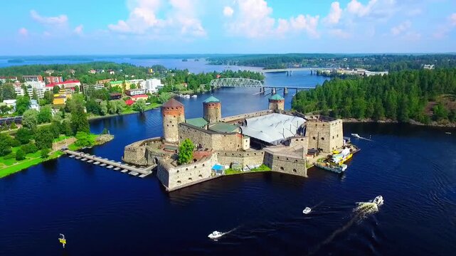 Aerial view of Olavinlinna Medieval Castle in Savonlinna, Finland. Beautiful summer landscape with blue lakes and clear sky