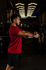 Man Performing Standing Cable Chest Fly Exercise in Gym