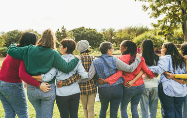 Multi generational women hugging each others - Female multiracial group having fun together outdoor...