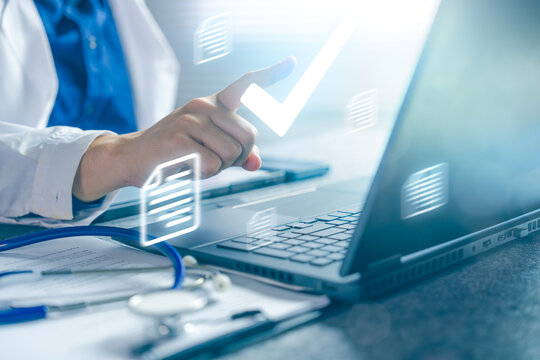 Doctor Approving Medical Documentation on Laptop with Digital Healthcare Workflow and Clinical Decision Concept