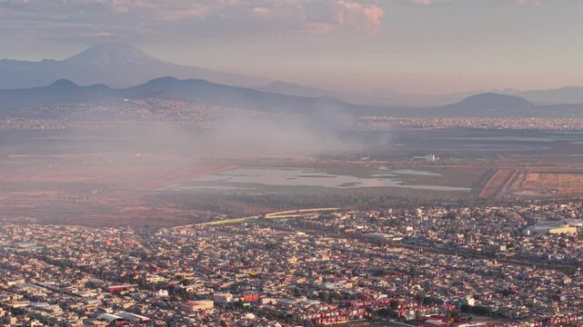 Aerial landscape of Valley of Mexico with smoke near Lake Texcoco