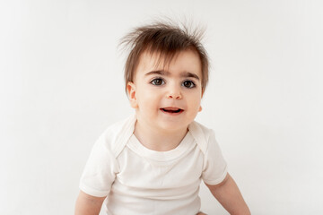 Naklejka premium cute baby on a white isolated background, space for text, baby boy in a white bodysuit smiling
