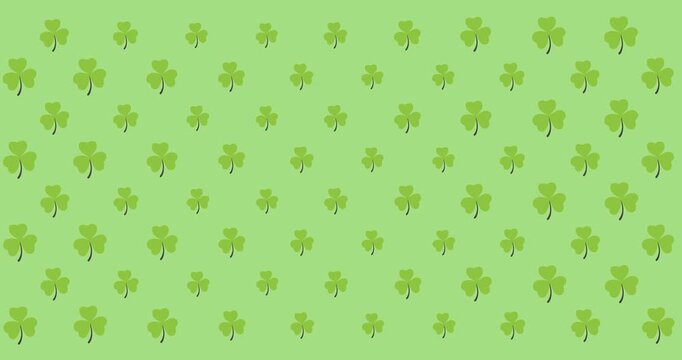 Digital animation of multiple clover leaves moving against green background