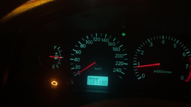Automotive instrument cluster illuminated with engine warning signals and digital readouts