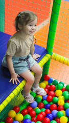 Children's playground. Ball pit. Child at a children's center.High quality photo