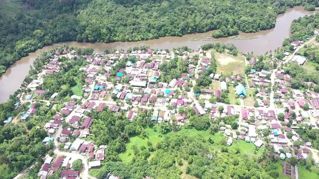 aerial view of the Buji River and its riparian settlement, where community life thrives amidst the lush Borneo rainforest.