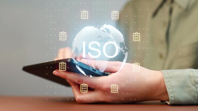 Person using tablet to access ISO standards information in a business setting.