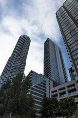 Fototapeta premium Modern skyscrapers and residential towers under cloudy blue sky