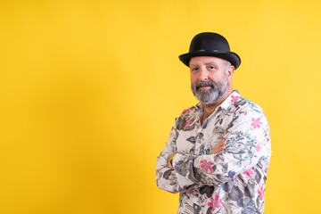 Confident man in bowler hat crossing arms