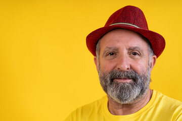 Mature bearded man wearing red hat smiling