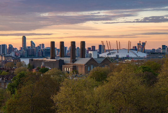 London, United Kingdom - April 19, 2025: A picture of the Greenwich Power Station and the O2 Arena at sunset.