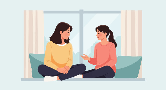 Two women sit facing each other near a window, sharing a moment of conversation