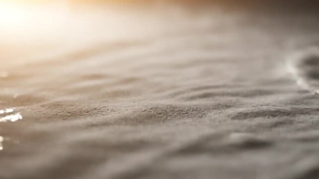 Water flowing on a surface, creating patterns from an initial dry state to wet and then receding, showing the fluid dynamics