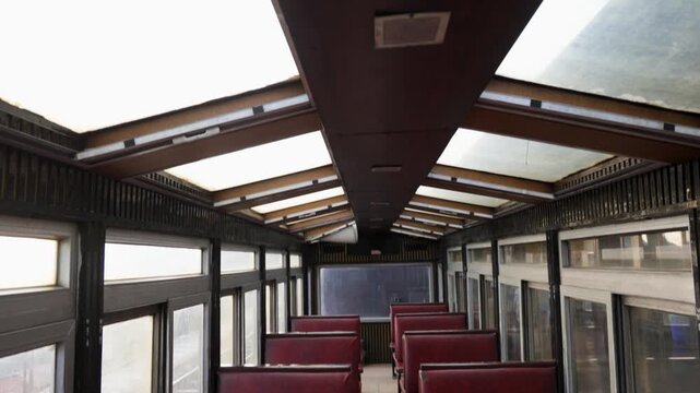 indian railway heritage vista dome passenger coach with red seats and wooden ceiling