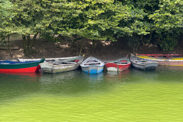 row of wooden fishing boats in the water