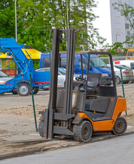 Orange Forklift Tuck Vehicle at Outdoor Parking