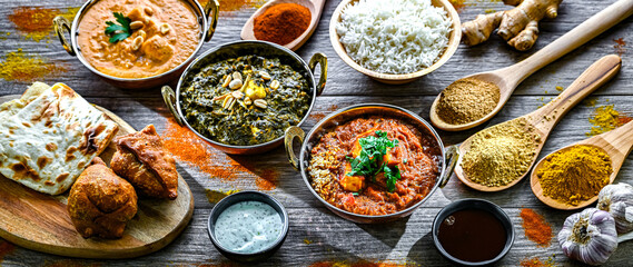 Composition with indian dishes: madras paneer, palak paneer and shahi paneer with basmati rice...