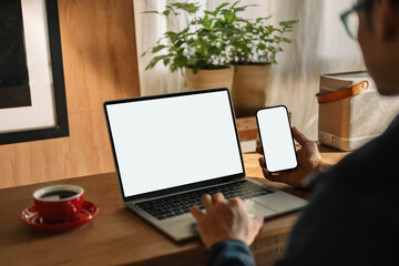 computer screen,mobile phone blank mockup.work using laptop texting cell phone.white background for...