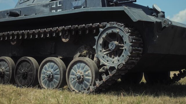 World War II theme open-air exhibition. Military vehicle. Historic WWII period. Balkenkreuz insignia. Reenactment. Military vehicle replica on display outdoors.