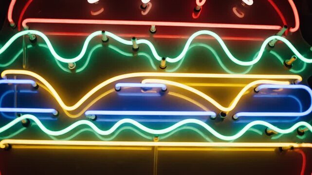 Colorful neon burger sign with layers of ingredients