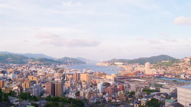 Nagasaki, Japan. Aerial timelapse made from a hill in Nagasaki, Japan, with a view over the entire center, including the bay and the hills. Cloudy and sunny day in summer