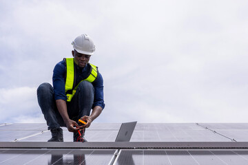Fototapeta premium Engineer service check installation solar cell on the roof of factory. Engineers walking on roof inspect and check solar cell panel. Engineer working inspection installation solar cell on the roof