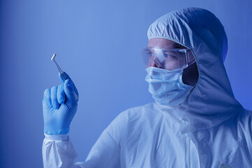 Naklejka premium Medical production, Scientist hold pill capsules for control medicine quality in pharmaceutical factory, blue light