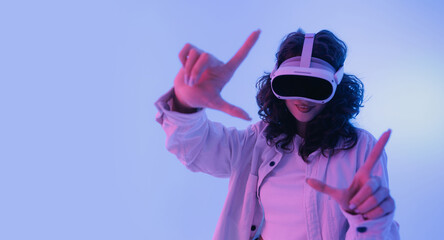 Fototapeta na wymiar Concept modern immersive digitalization and technology. Young asian female enjoying virtual reality experience with headset