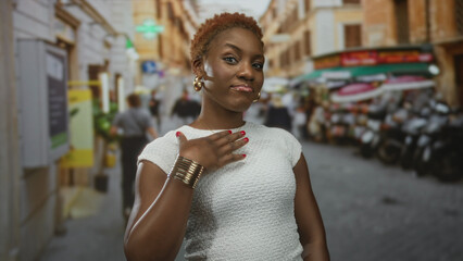 Young african american woman points finger to a gold necklace while standing on a bustling city...